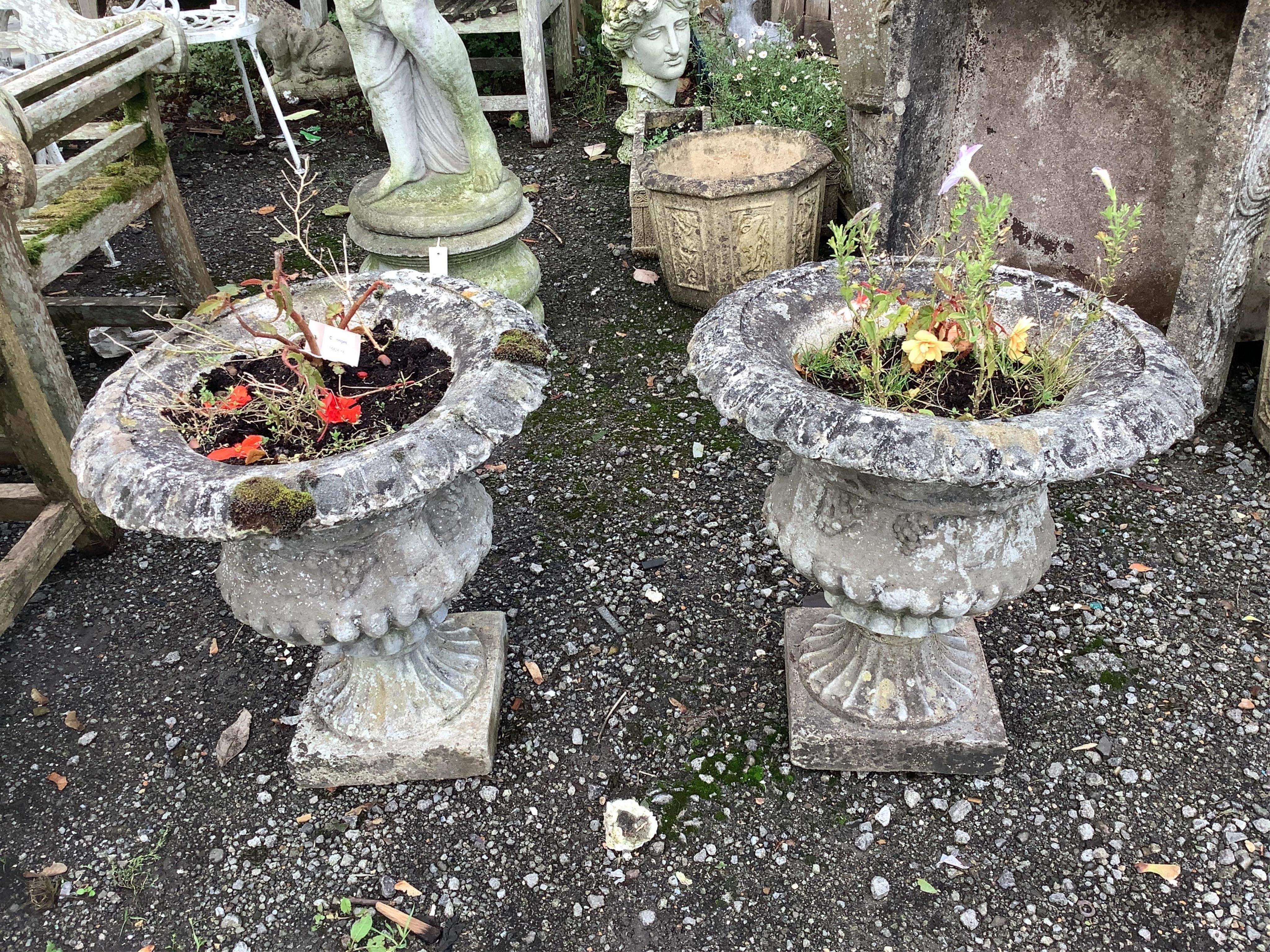 A pair of circular reconstituted stone campana garden urns, diameter 51cm, height 54cm. Condition - fair